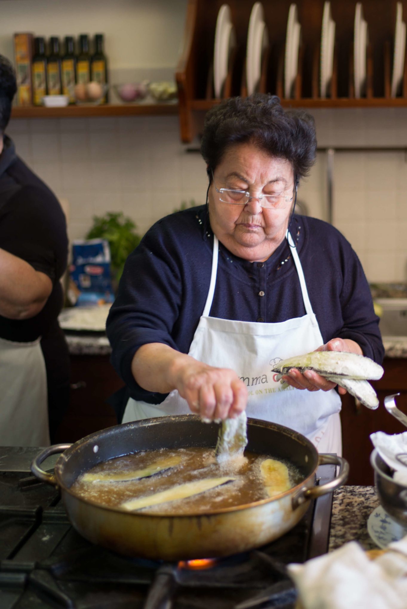 Mamma Agata frying eggplant for her eggplant parmesan - the taste edit