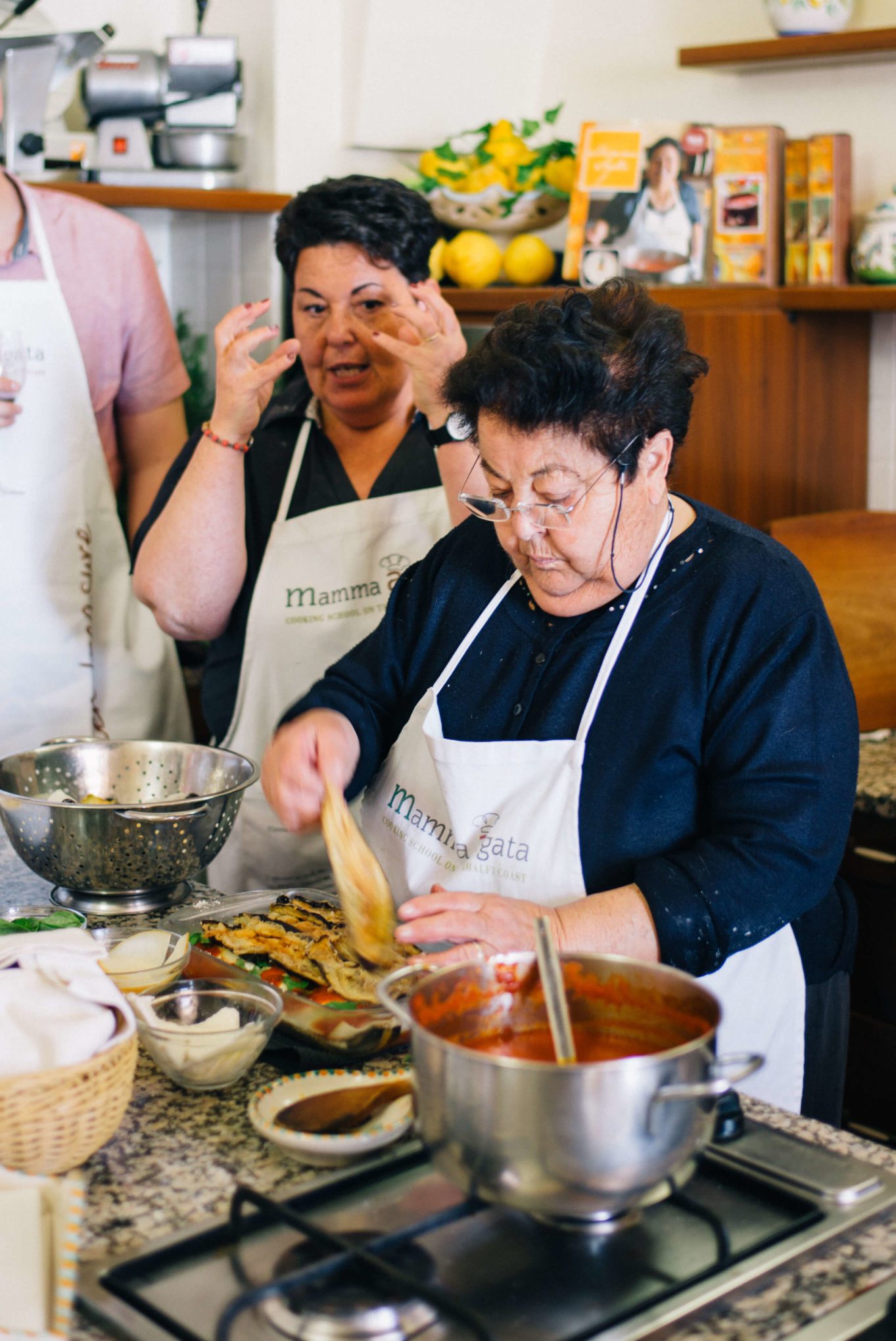 Mamma Agata, in the kitchen with an Italian Grandmother in Ravello making authentic eggplant parmesan in the amalfi coast, ravello - layering eggplant with her famous tomato sauce recipe, thetasteedit #recipe #food #italianfood #sauce #tomato