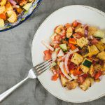 we toss cucumber, bread, tomatoes, and purple onion for the pazanella salad recipe by The Taste Edit