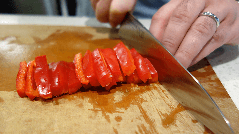 pepper being cut for making paella