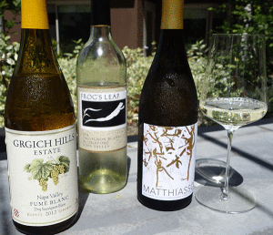 Bottle of Grgich Hills Estate Fume Blanc, Bottle of Frog’s Leap Sauvignon Blanc, Bottle of Matthiasson Chardonnay , glass of wine