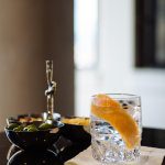 The Taste Edit likes to serve olives, nuts, and potato chips with their gin and tonics with grapefruit and juniper berries.