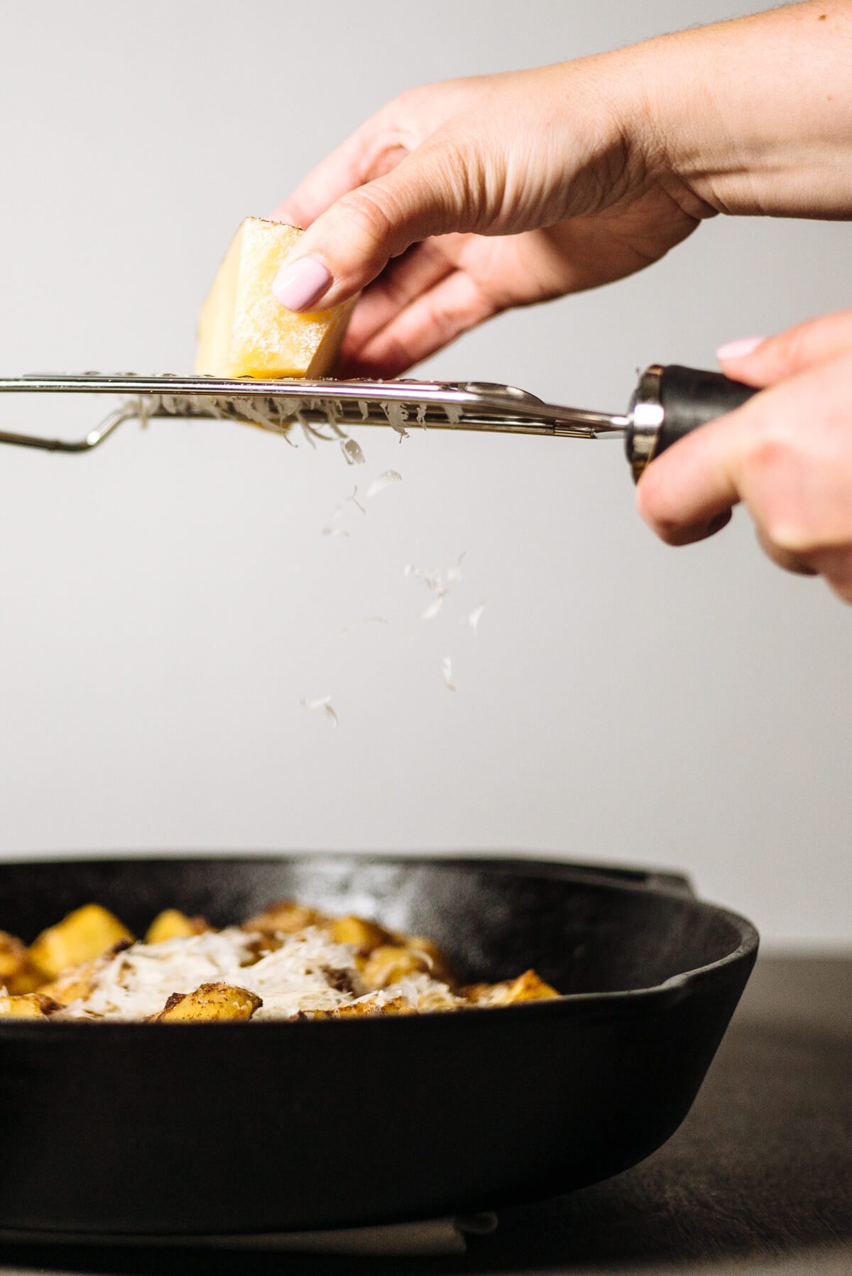 grating cheese to top cast iron skillet manchego cheese potatoes