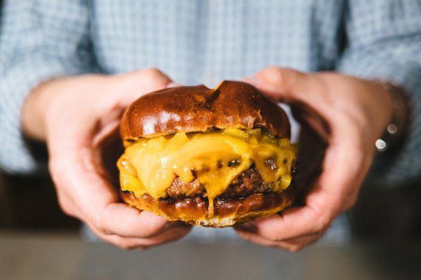 Green chili cheeseburger with pretzel buns from The Taste Edit