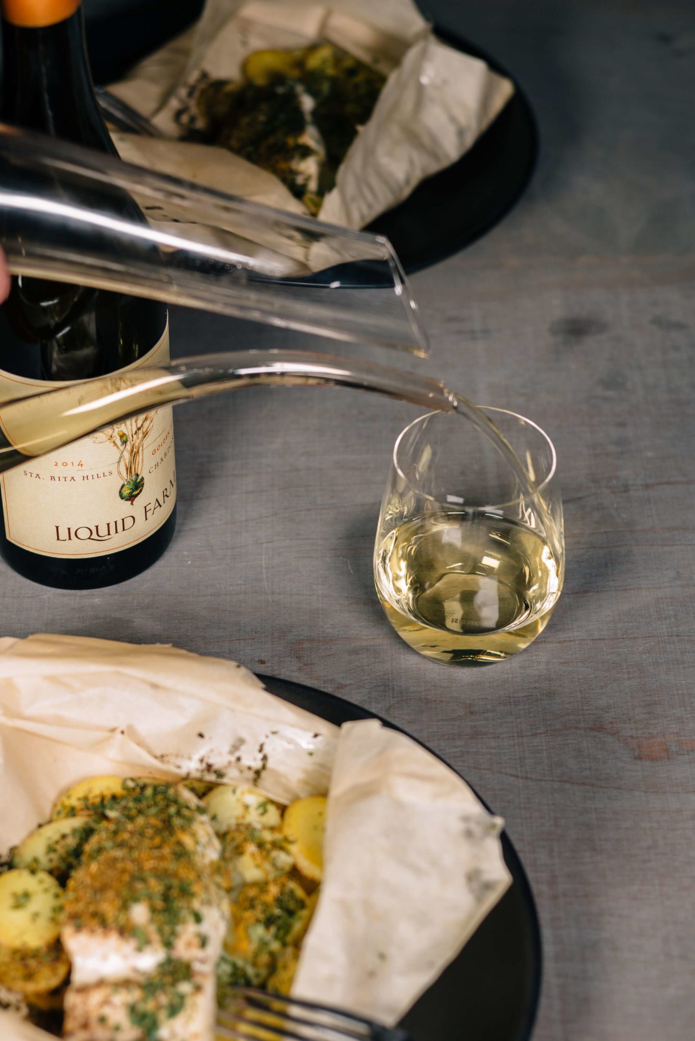 Halibut fish with fennel pollen and potatoes baked in parchment paper with the taste edit and liquid farm wine