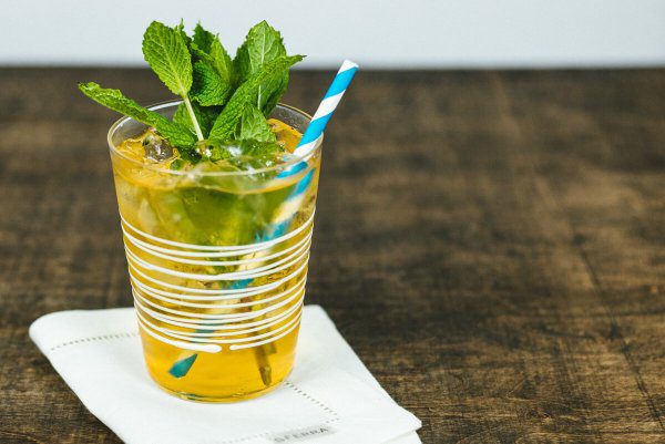 Mint Julep recipe by The Taste Edit served in a zafferano glass with a paper straw