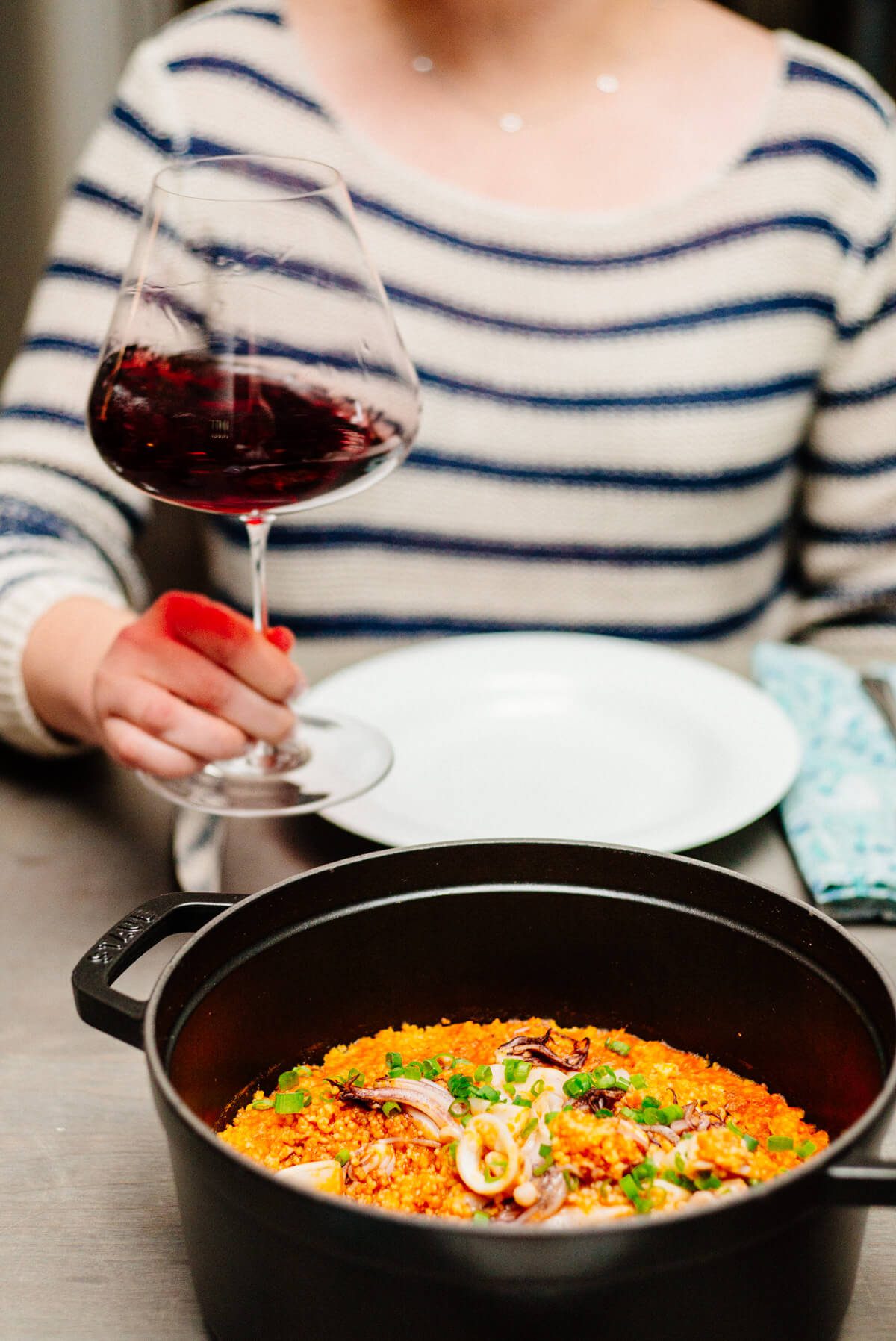 Drinking pinot and eating calamari in spicy tomato sauce