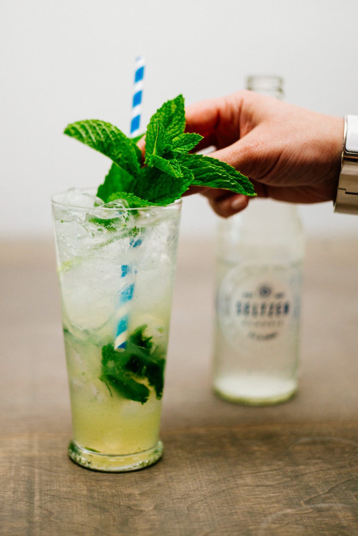 Garnishing a classic mojito with mint
