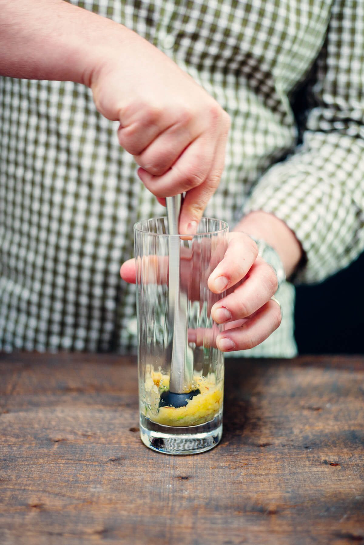 Muddling apples and rosemary for a Conquistador's Tonic cocktail