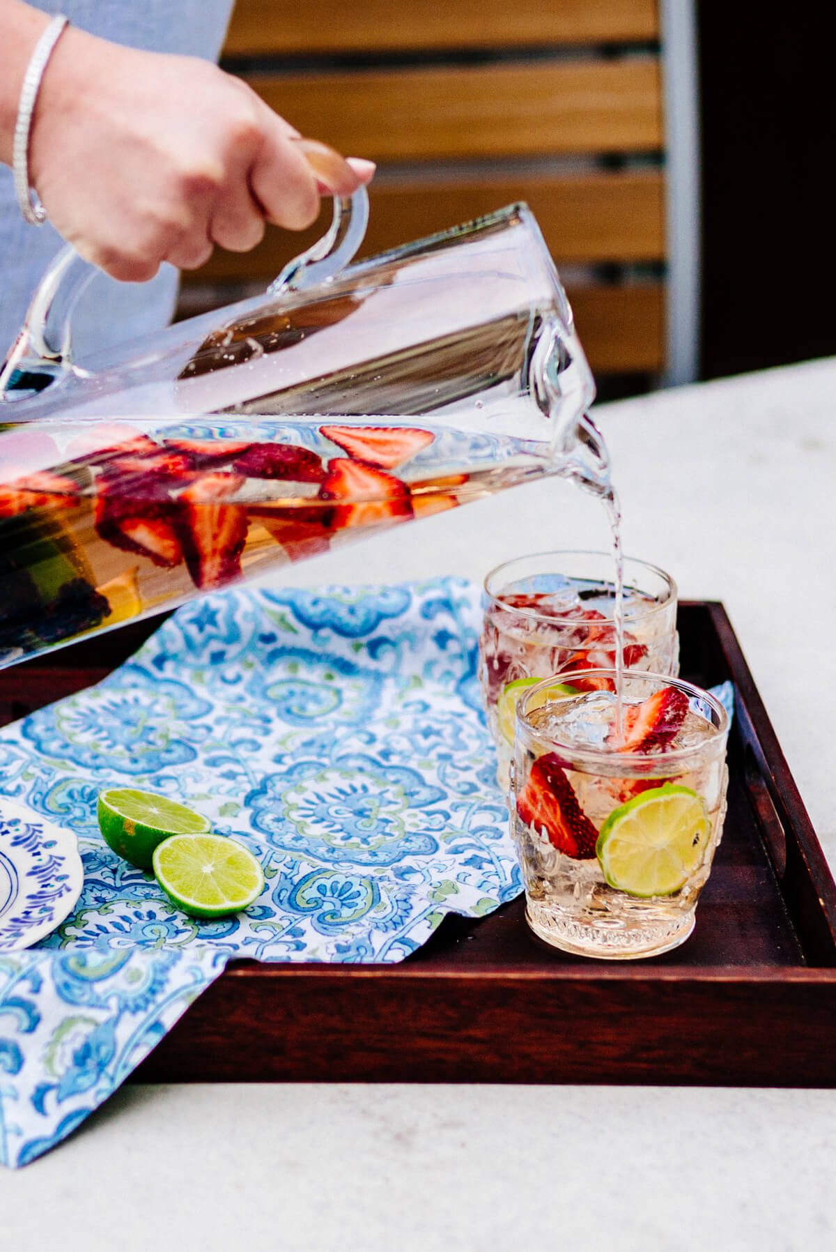 Pouring Rose Sangria into glasses