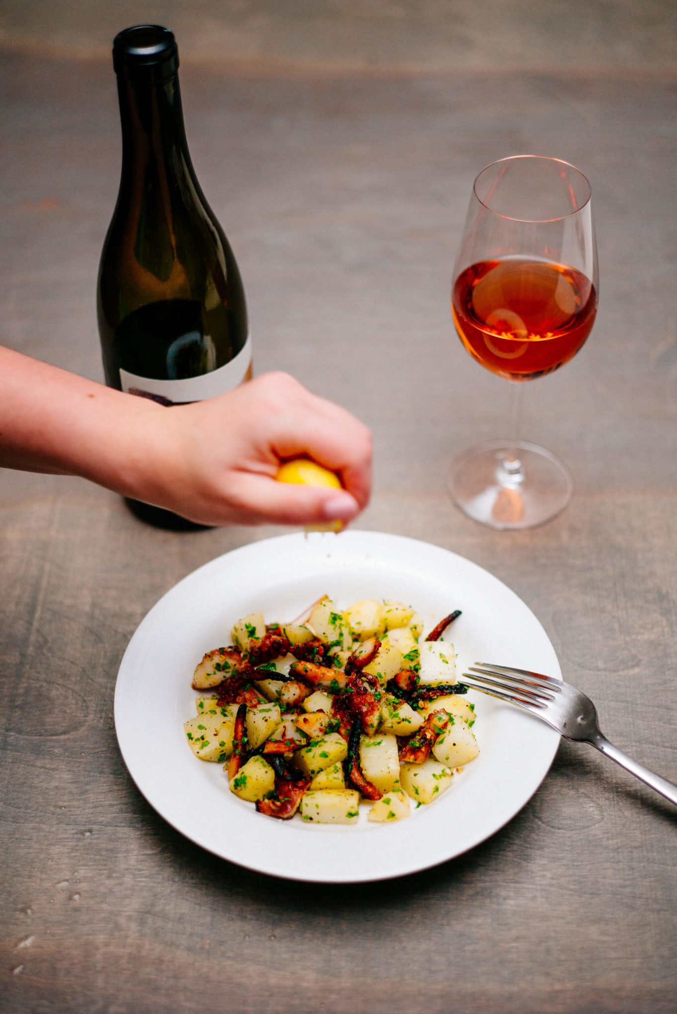 Squeezing lemon on our grilled octopus salad
