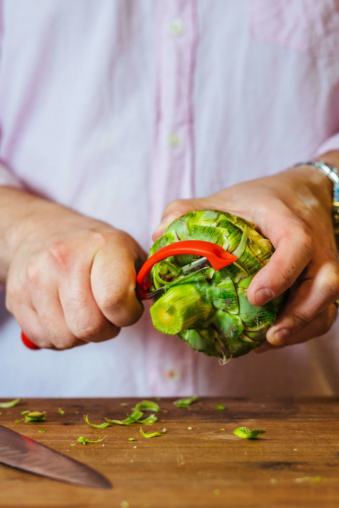 how to trim an artichoke - trim the bottom stem with a peeler