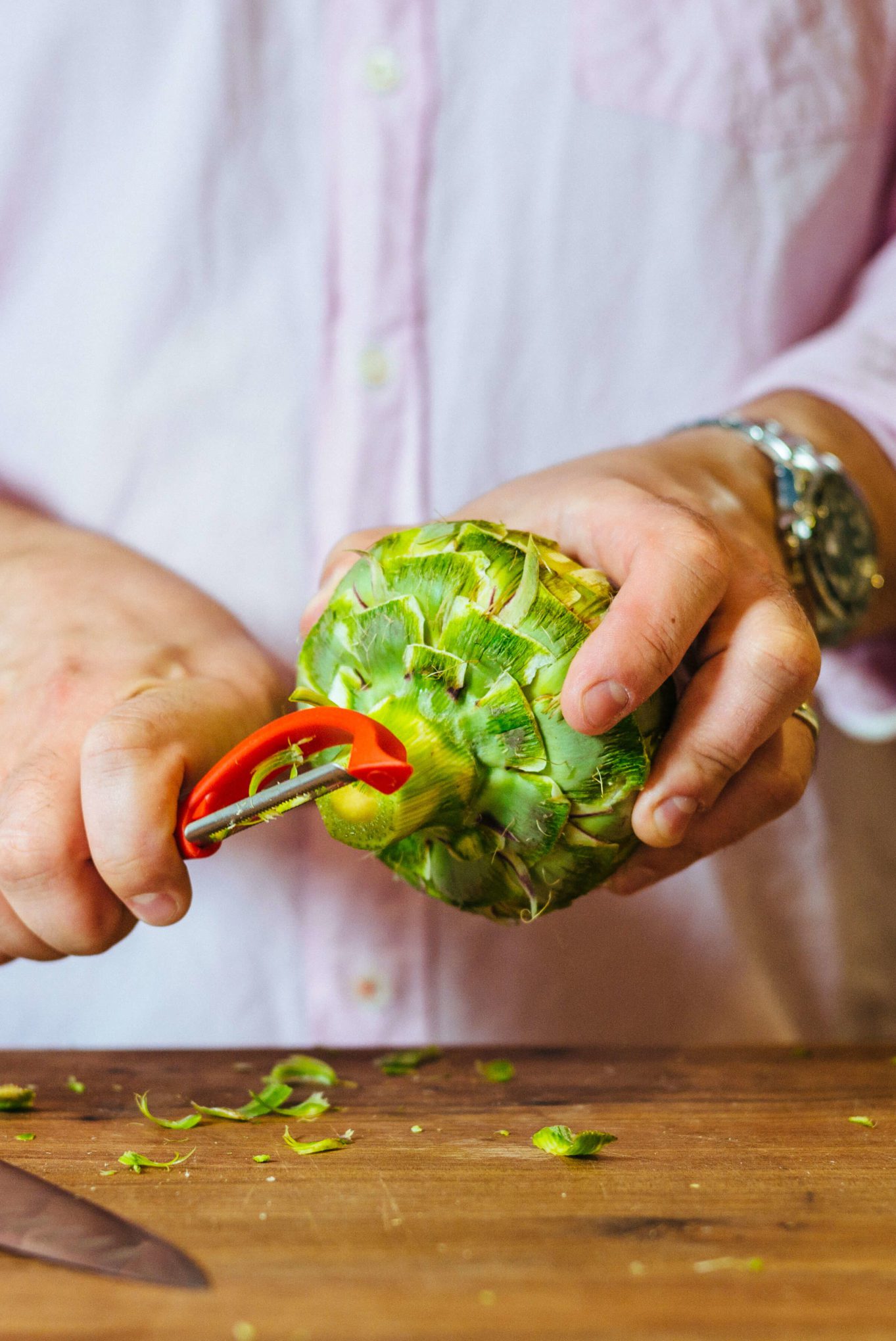 how to trim an artichoke - trim the bottom stem with a peeler to get off the rough part