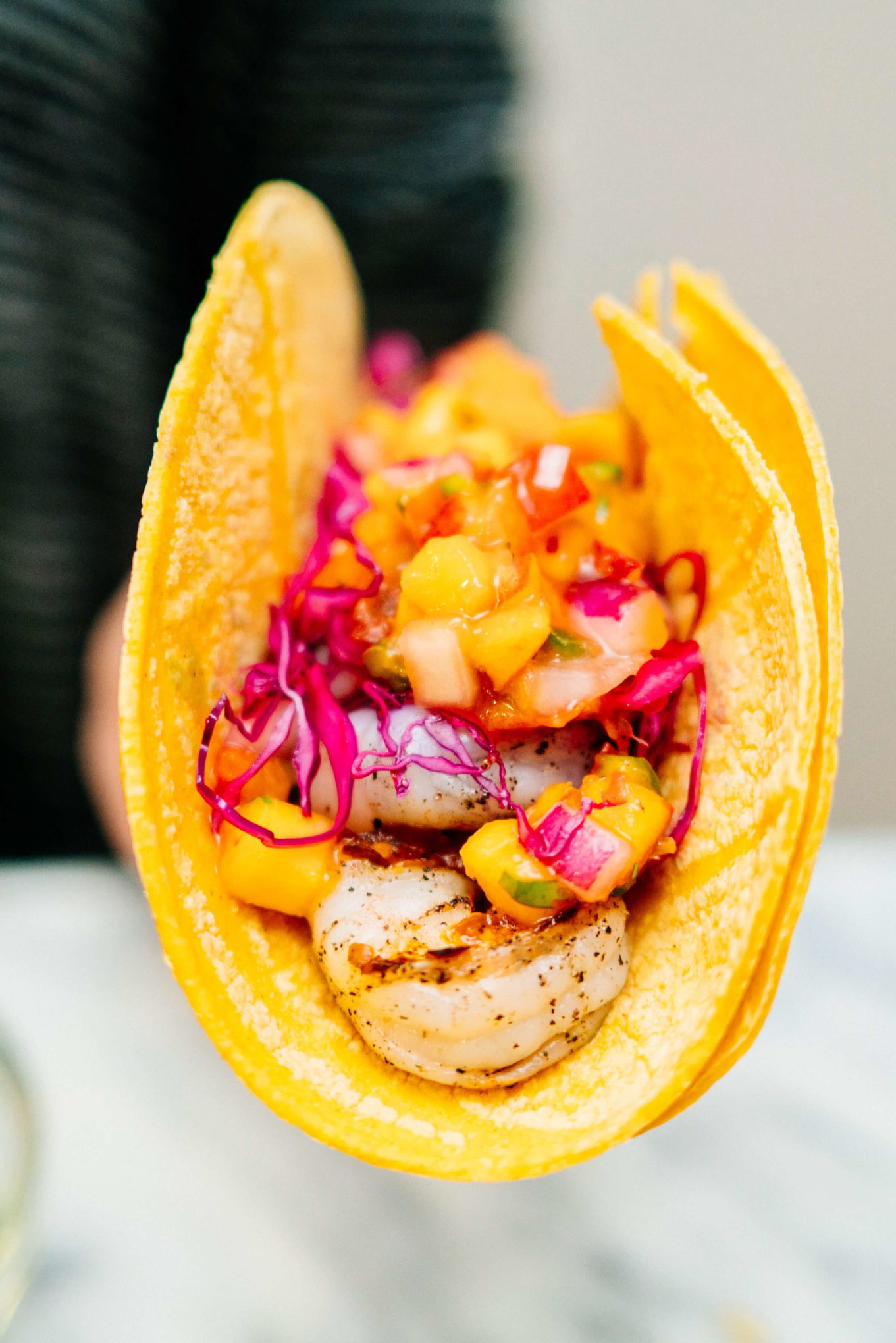 We love using corn tortillas to make shrimp tacos with peach salsa and cabbage