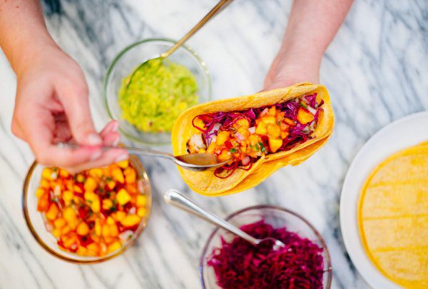 Shrimp tacos with peach salsa and toppings is perfect for summer