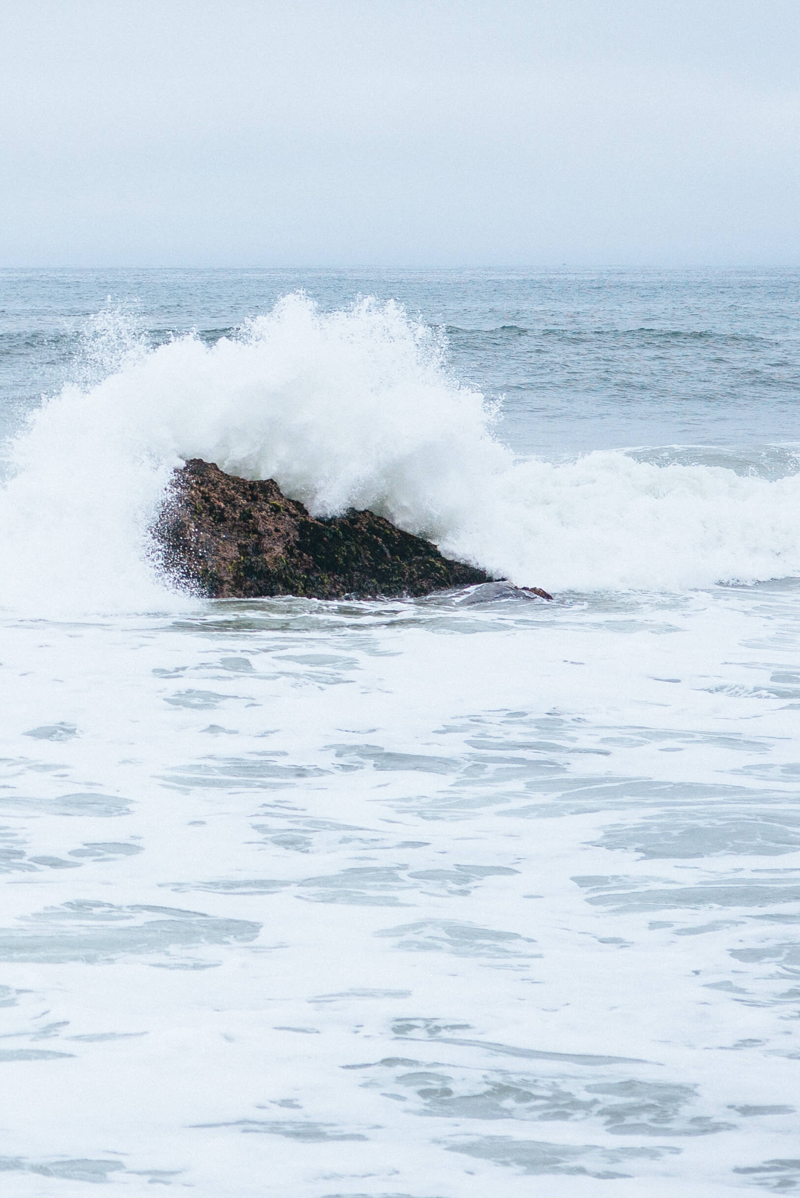 The beach at The Ritz-Carlton Half Moon Bay ocean breaking on rocks