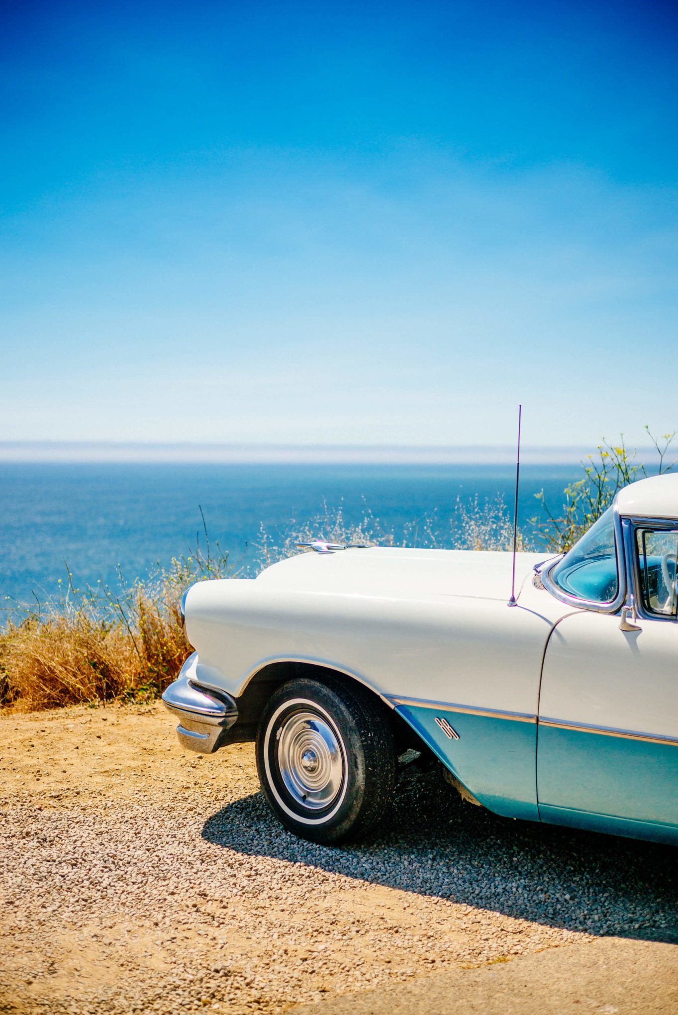 The Taste Edit spots an antique car overlooking the Pacific Ocean on highway one California coast.