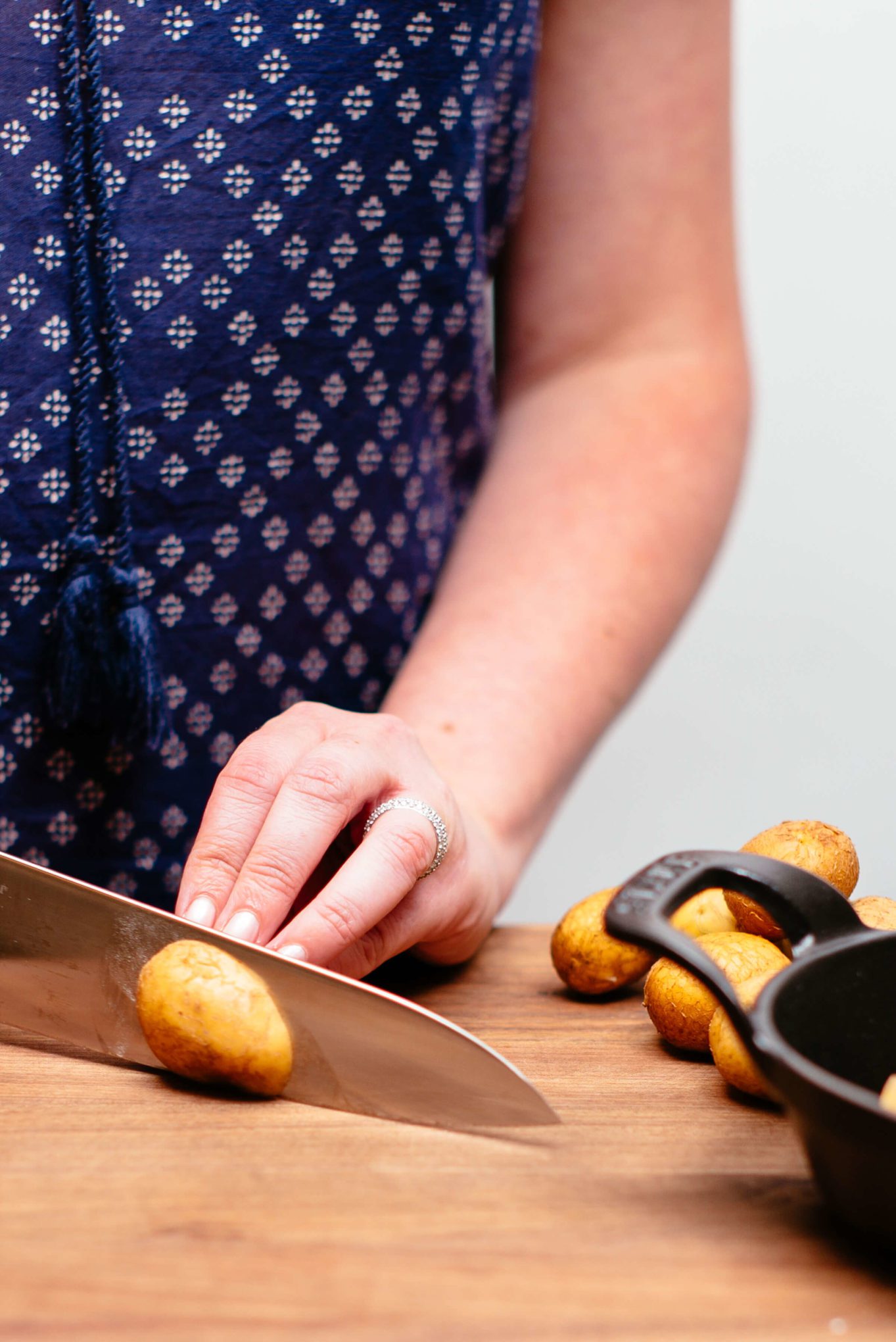 Chopping potatoes to make herb roasted potatoes