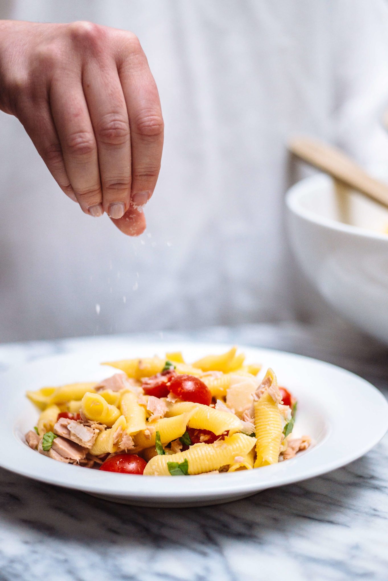 Top the pasta with tuna and cherry tomatoes with salt