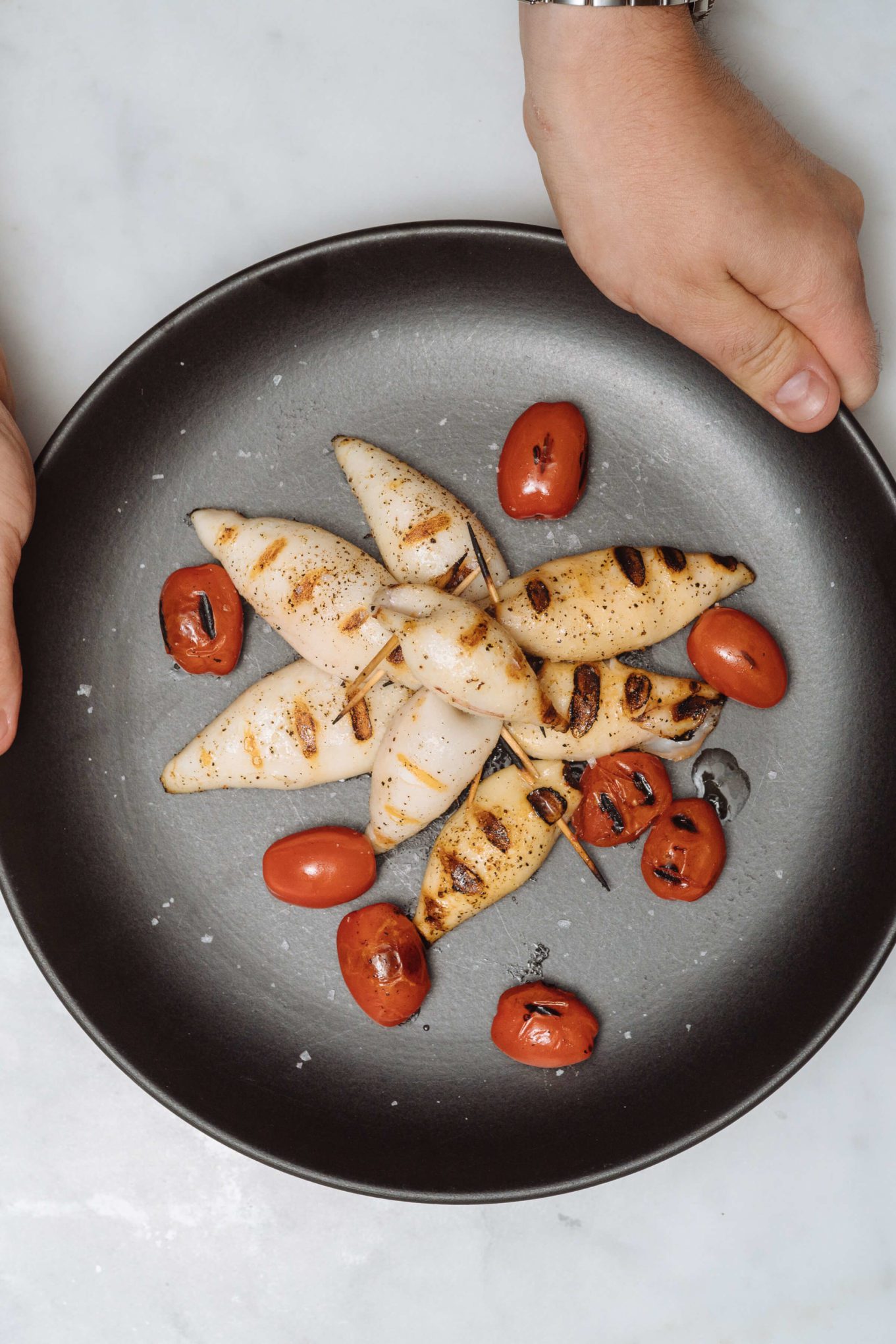 Placing the stuffed squid out for an appetizer at a dinner party