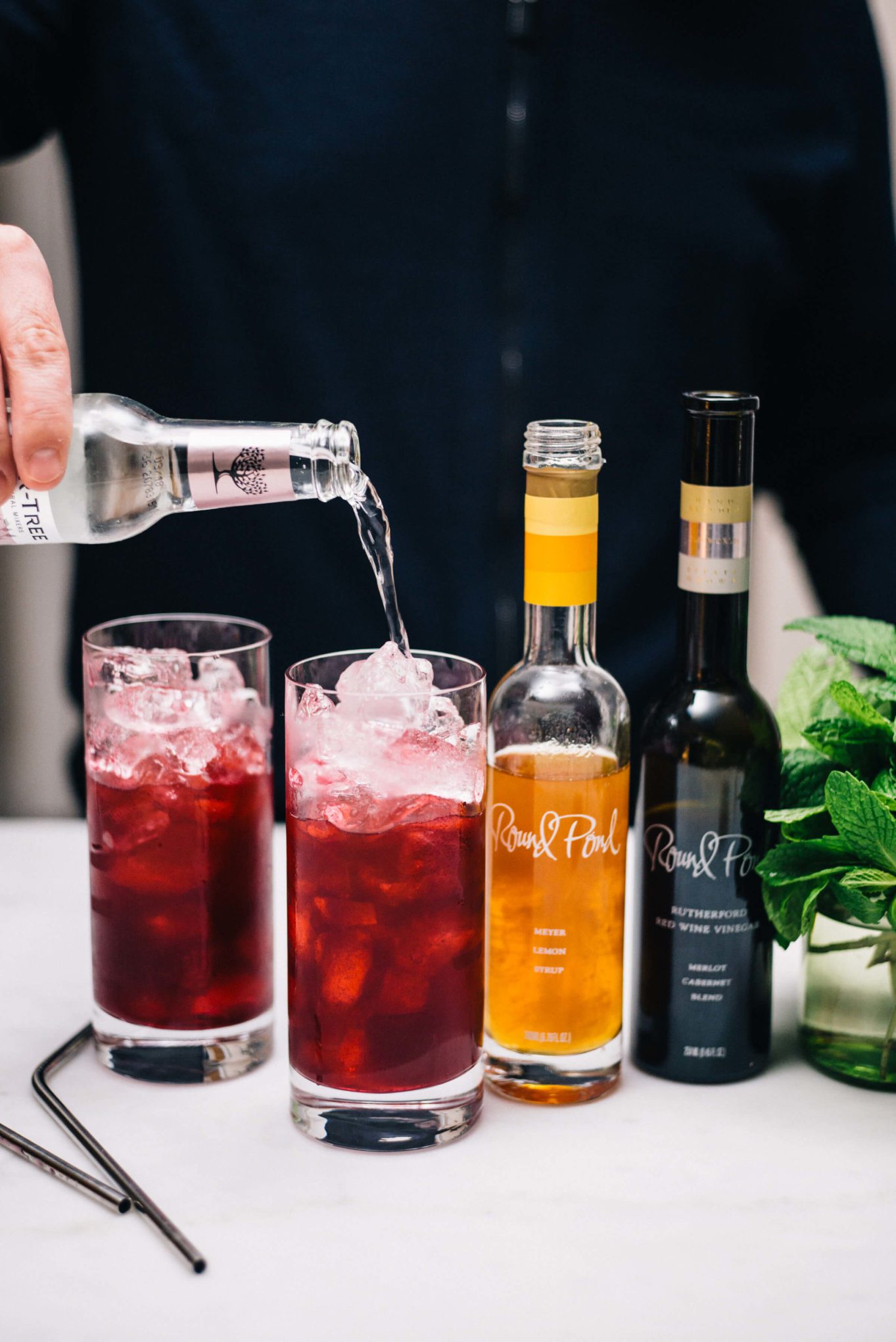 Topping off this Blueberry Shrub Cocktail made with gin and club soda | Round Pond Estate Napa Rutherford | The Taste Edit