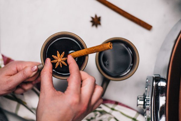 Adding cinnamon and star anise to mulled wine in an All-Clad Gourmet Slow Cooker with The Taste Edit