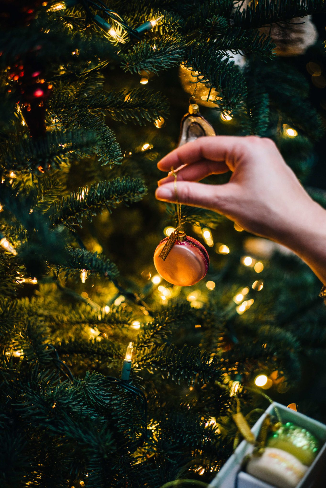 Hanging Christmas tree ornaments and decorating the tree is a favorite way to celebrate Christmas at the taste edit