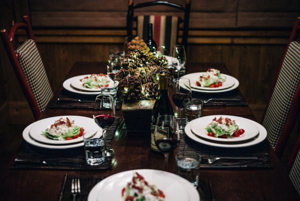The table was set with wine, pinecones, and lights for a steakhouse style steak dinner with the taste edit in tahoe