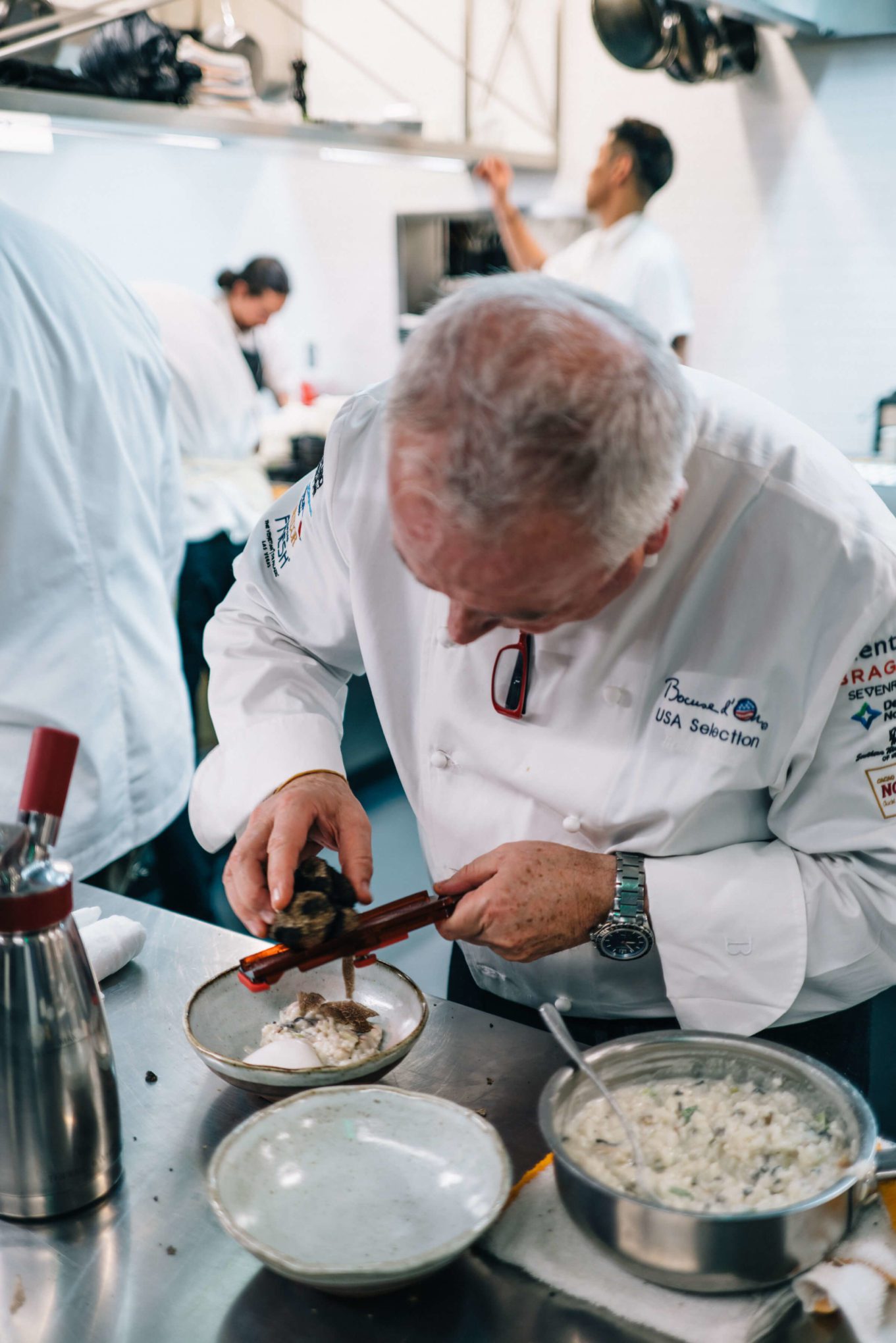 Roland Pastor of La Foile adding black truffle to his wild mushroom risotto at Ment'or BKB's send off celebration for Team USA 2017 to the Bocuse D'or with The Taste Edit