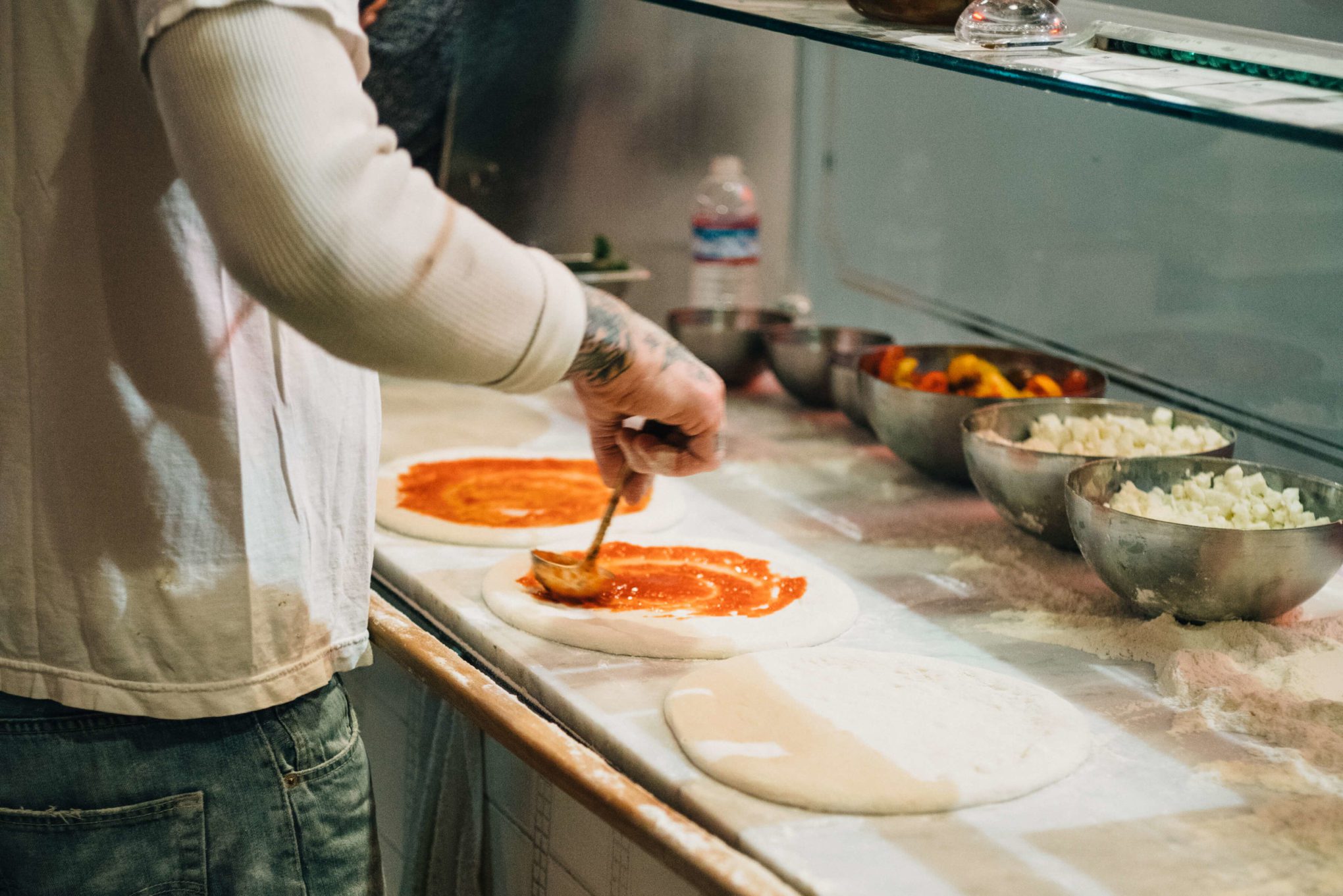 Anthony Mangieri adds sauce while Making Neapolitan Pizzas Una Pizza Napoletana in in San Francisco with The Taste Edit