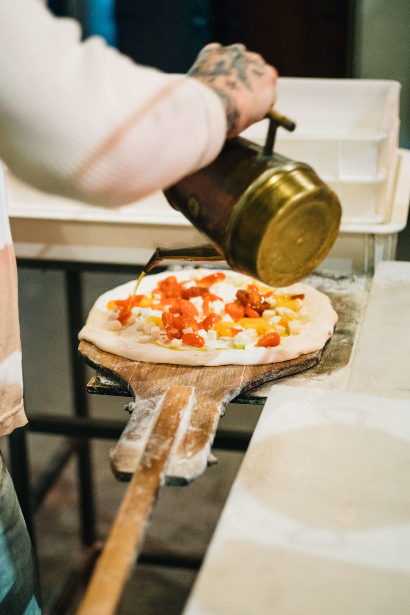 Anthony Mangieri adding olive oil while Making Neapolitan Pizzas Una Pizza Napoletana in in San Francisco with The Taste Edit