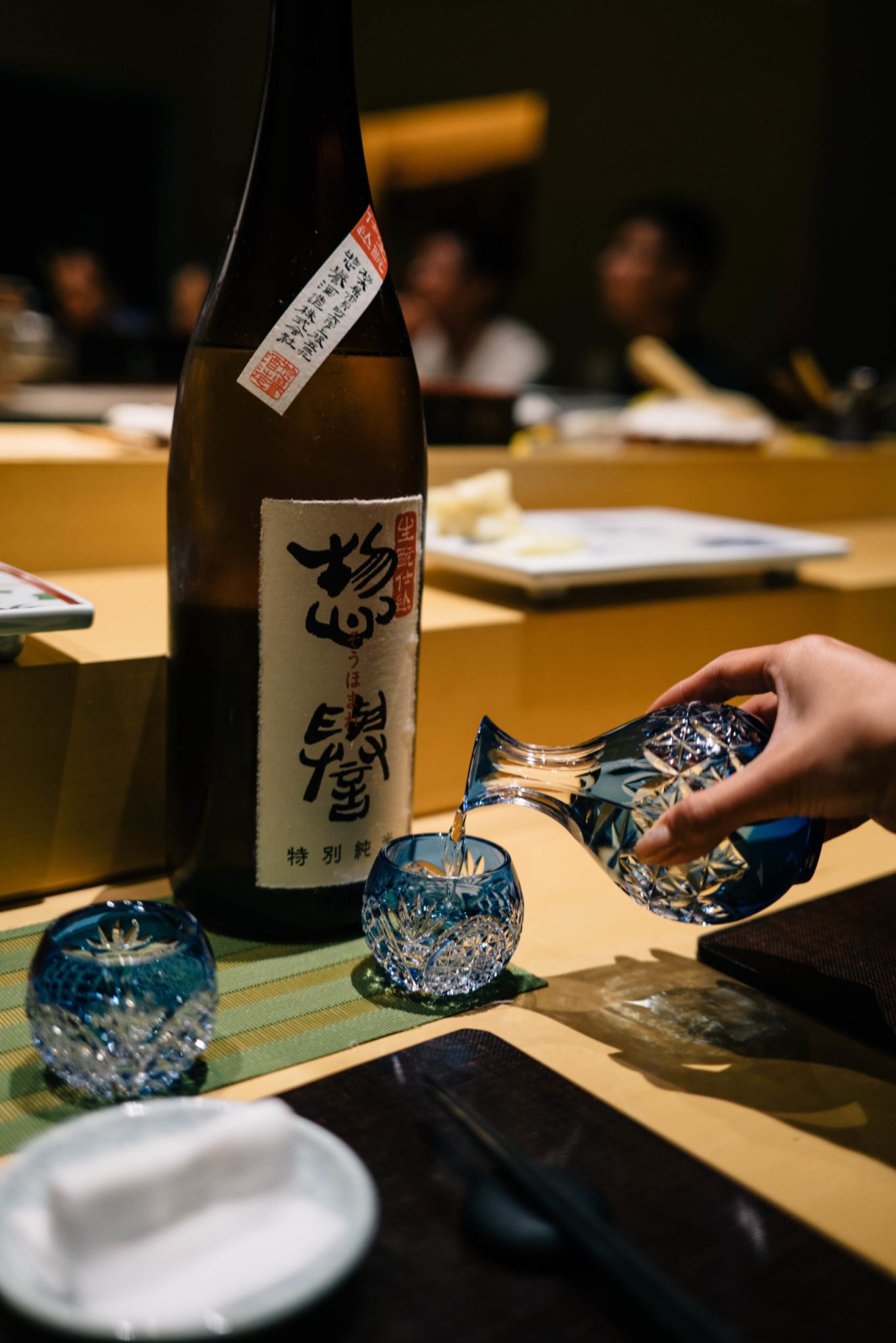 Pouring saki in served in rare crystal cups at San Francisco's Omakase restaurant, The Taste Edit