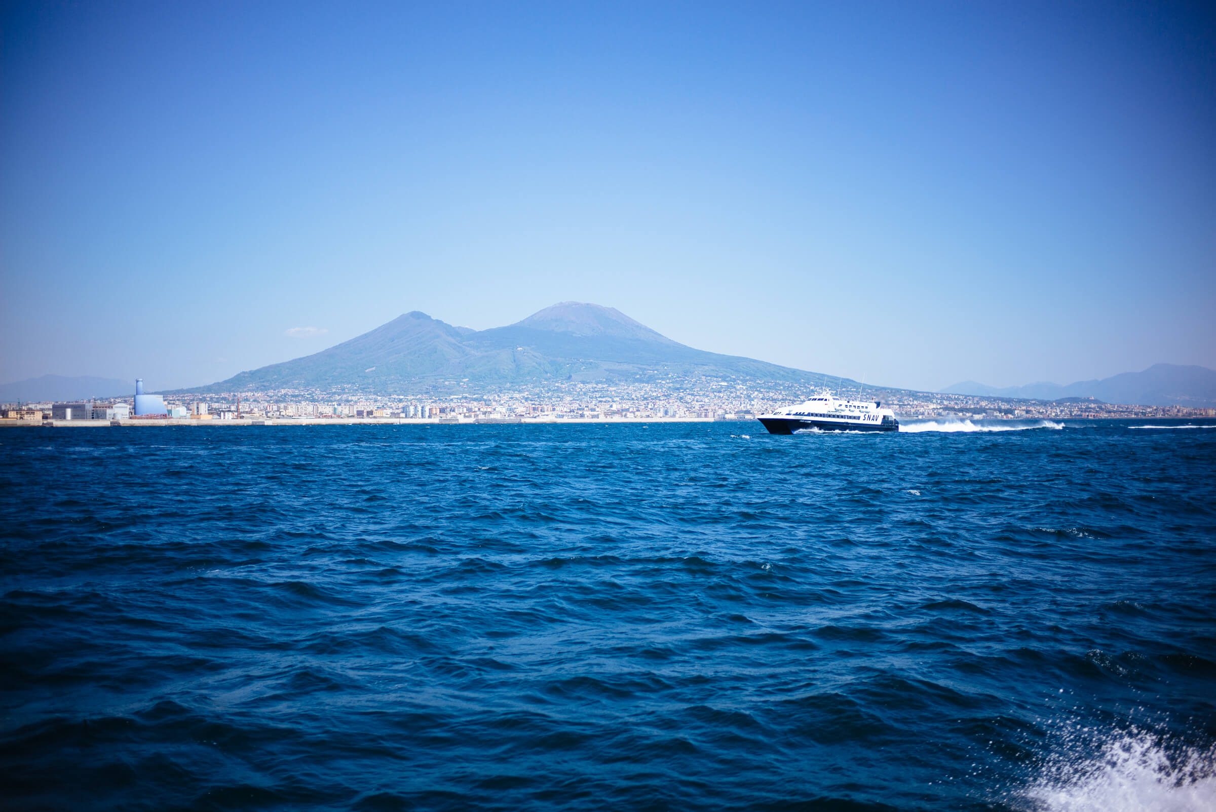 Use highspeed ferries to get around the Amalfi Coast in Italy. Mount Vesuvius from the high speed ferry from Napoli to Capri