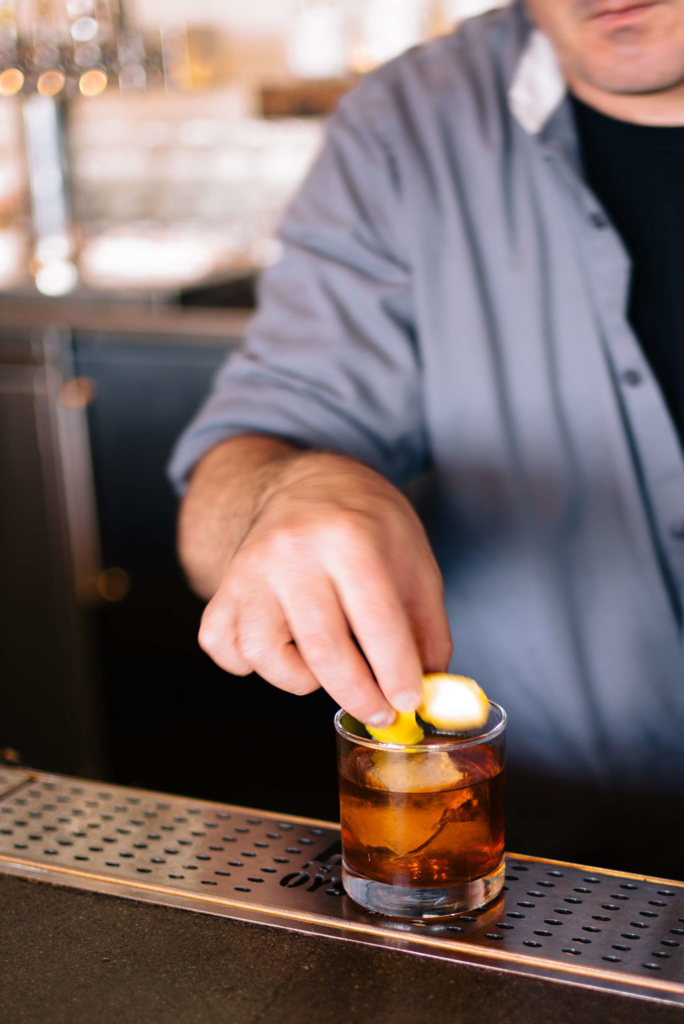 Adding garnish to the San Francisco Hog Island's Port Authority Old Fashioned COcktail, The Taste Edit