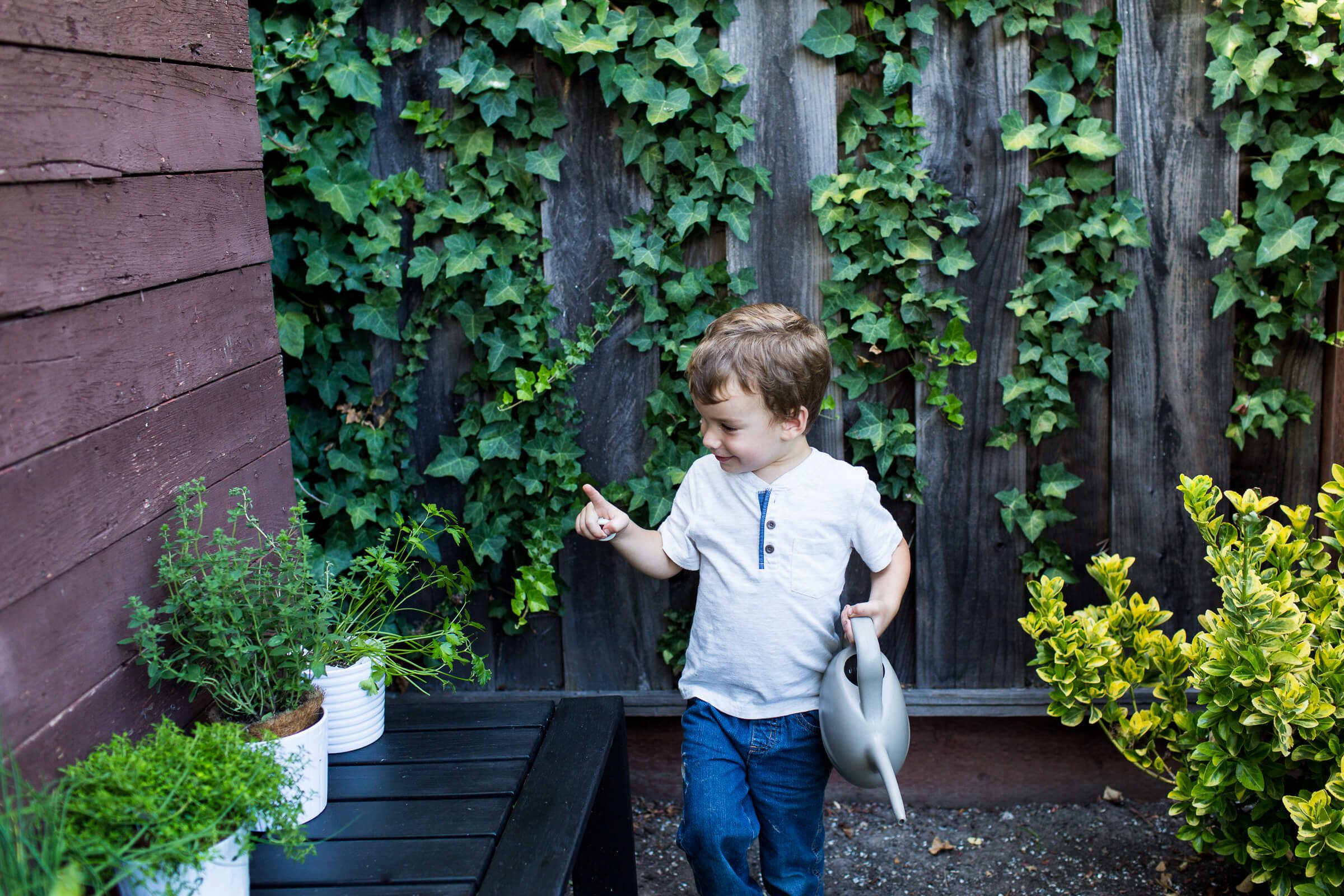 Sam helping to water his Herb Garden, teaching children about food and herbs with Elise from The Curiosity Project, The Taste Edit