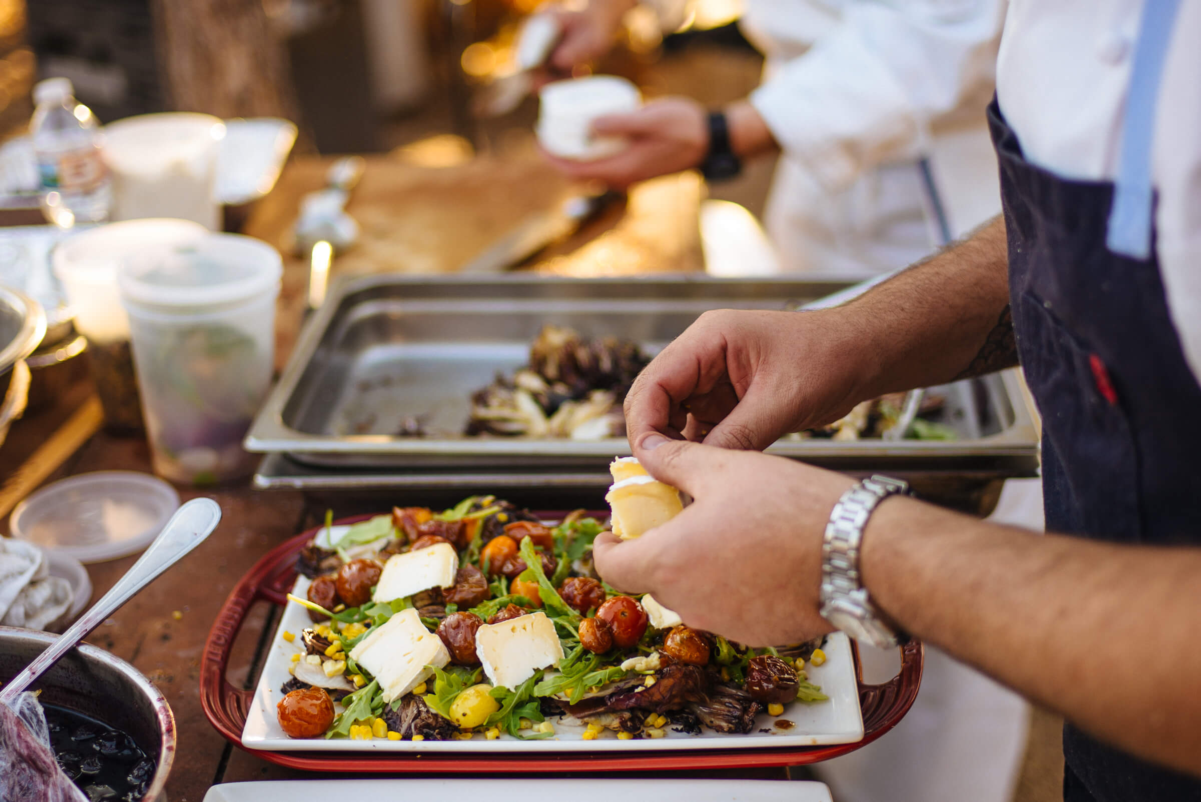 Greg Denton makes the best Grilled Radicchio and corn salad with Mt Tam triple cream and roasted tomato vinaigrette at The Resort at Paws Up Cookbook Live during the chuckwagon, The Taste Edit