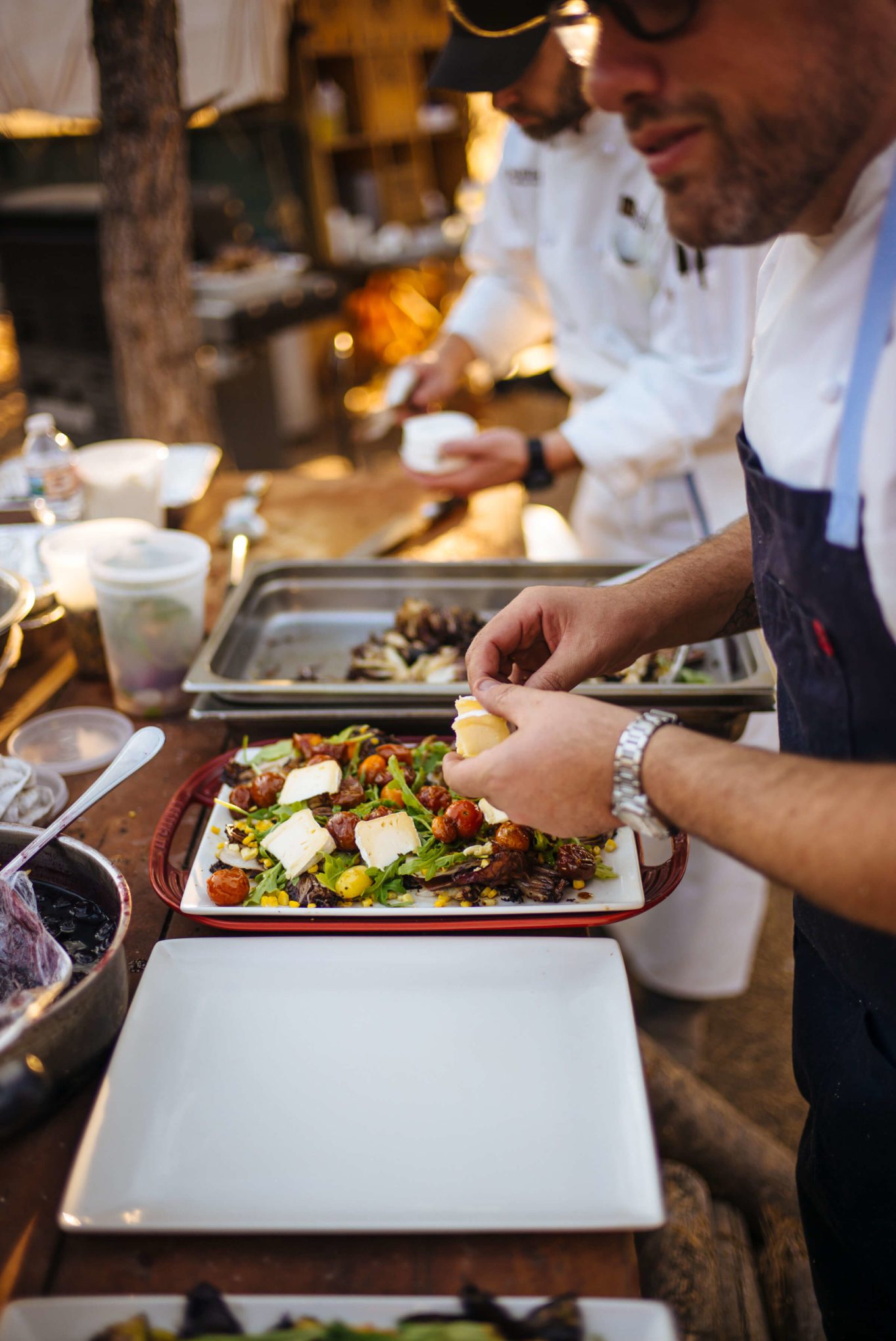 Greg Denton makes their Grilled Radicchio and corn salad with Mt Tam triple cream and roasted tomato vinaigrette at The Resort at Paws Up Cookbook Live during the chuckwagon, The Taste Edit