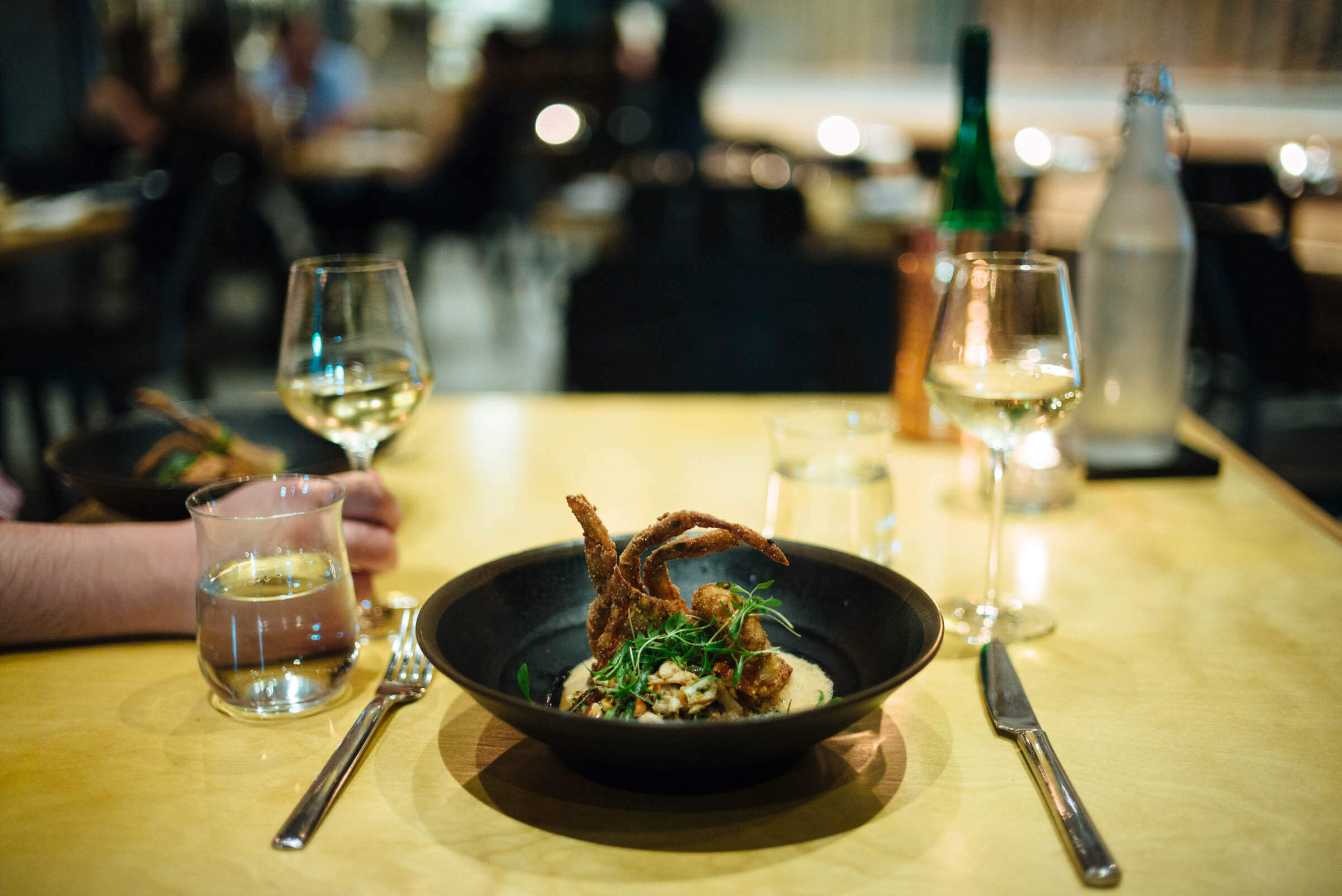 Try this place on a French classic, the Crispy Fried Softshell Crab Amandine $35 brown butter, blue crab, and shaved bean salad, marcona almonds, coconut lime leaf meunière at the best restaurant in new orleans, Maypop Restaurant in NOLA, The Taste Edit