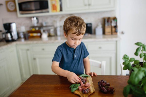 Charcuterie lunch ideas for kids including cheese, crackers, grapes, and meats