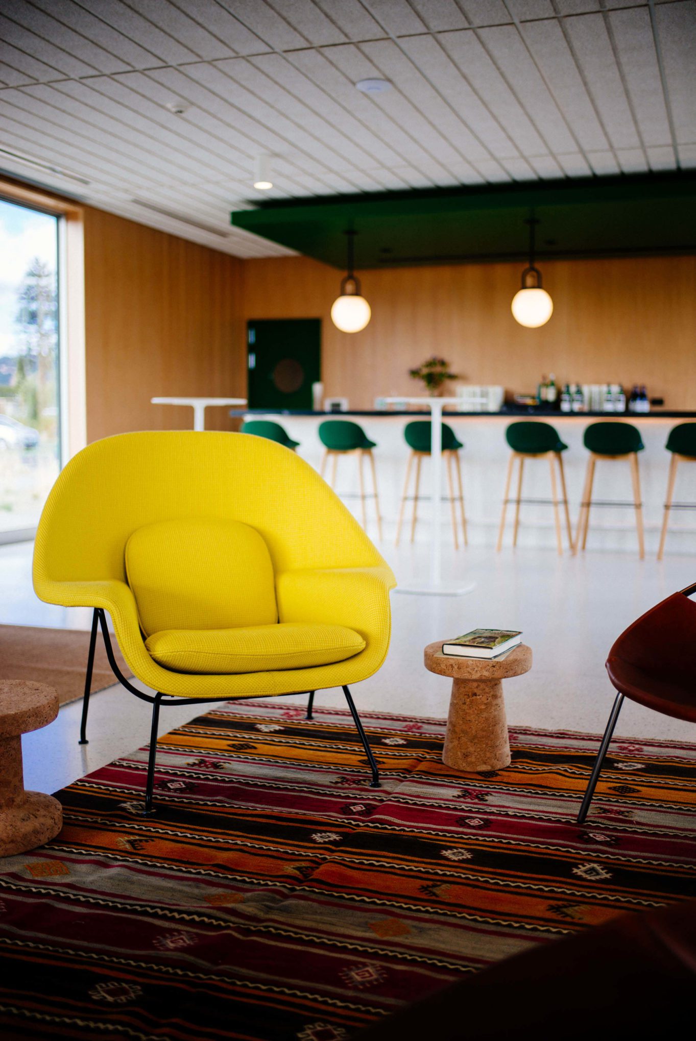 Ashes and Diamonds winery Napa Valley Wine Tasting Room, inspired by the 1960s mid century includes a knoll womb chair in kato yellow fabric, The Taste Edit