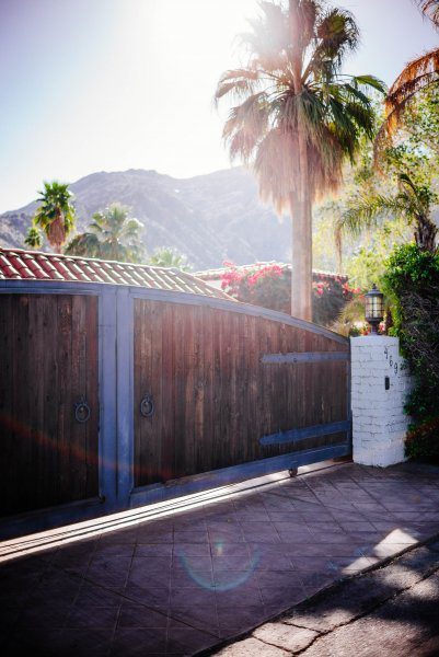 The wooden gate holds back a beautiful home in Palm Springs : Tour the beautiful Mid Century Homes in Palm Springs, The Taste Edit