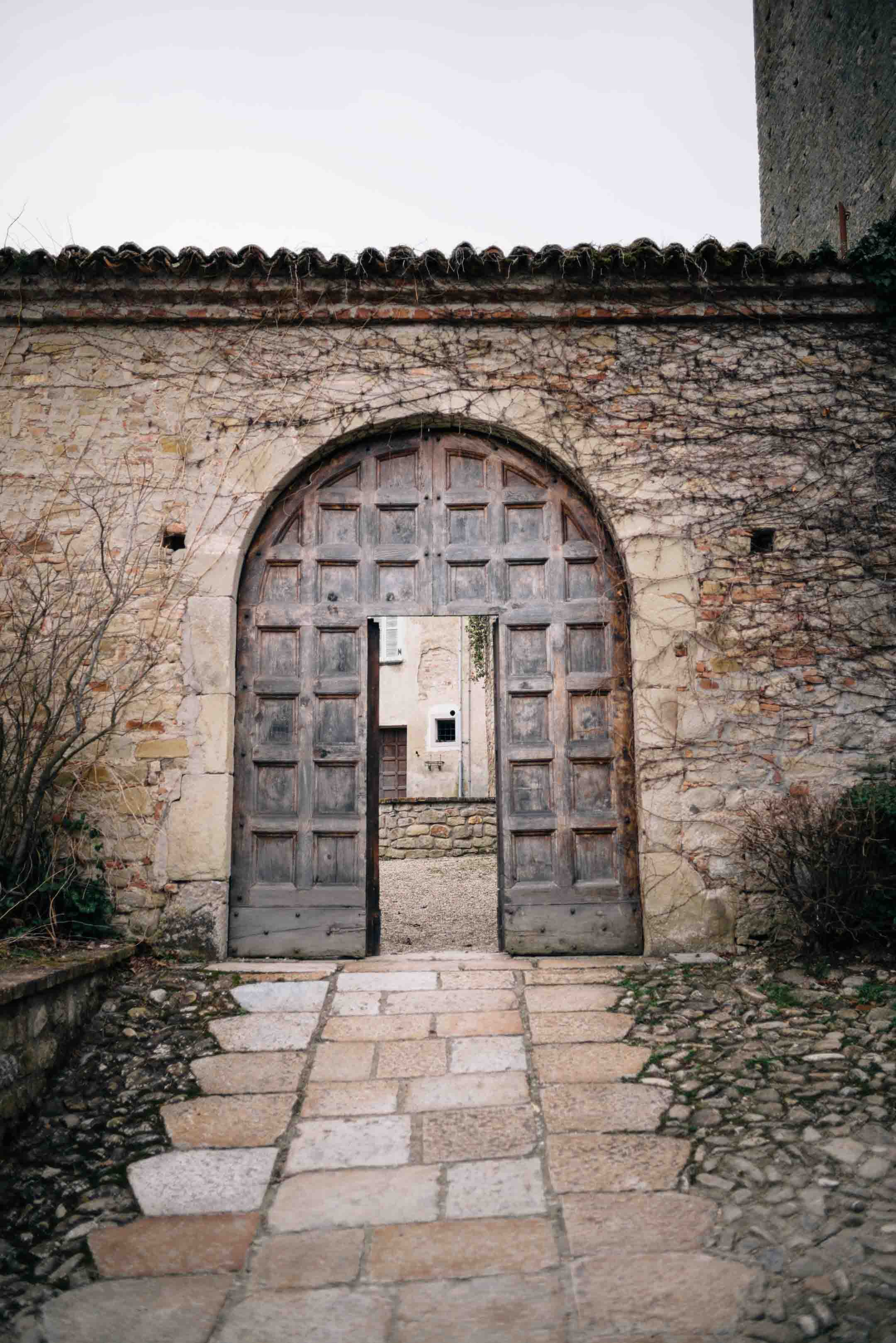 The Taste Edit, culinary photographers, recommends visiting this magical winery in northern Italy. Castello di Stefanago is near the town of Pavia in Lombardy. Winemaker and owner Giacomo Baruffaldi gives us a tour of the winery where they make Baruffaldi natural wines. The huge door to the beautiful castle.