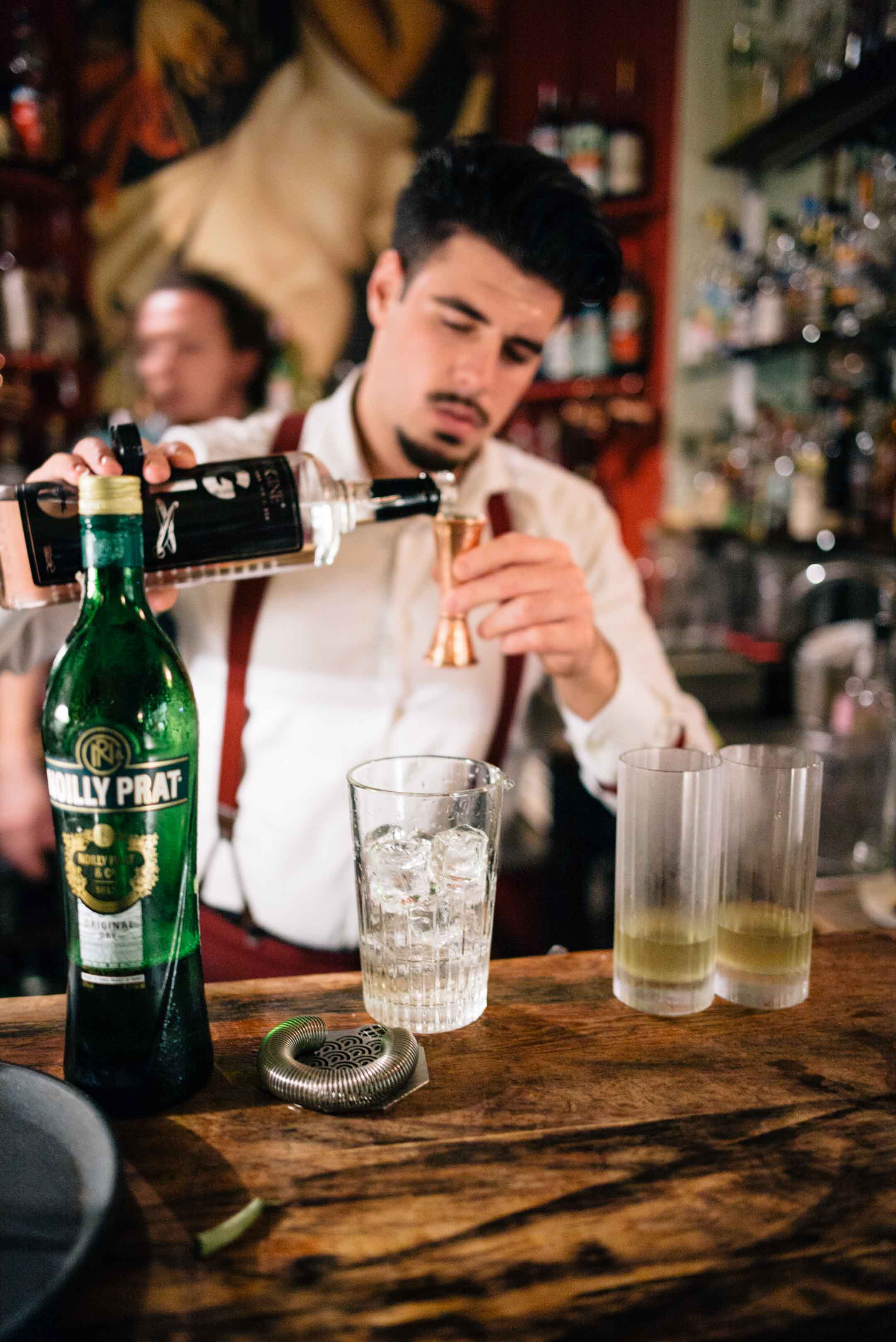 Bartenders make amazing cocktails at the bar at Les Rouges cocktail bar in Genova, Italy.