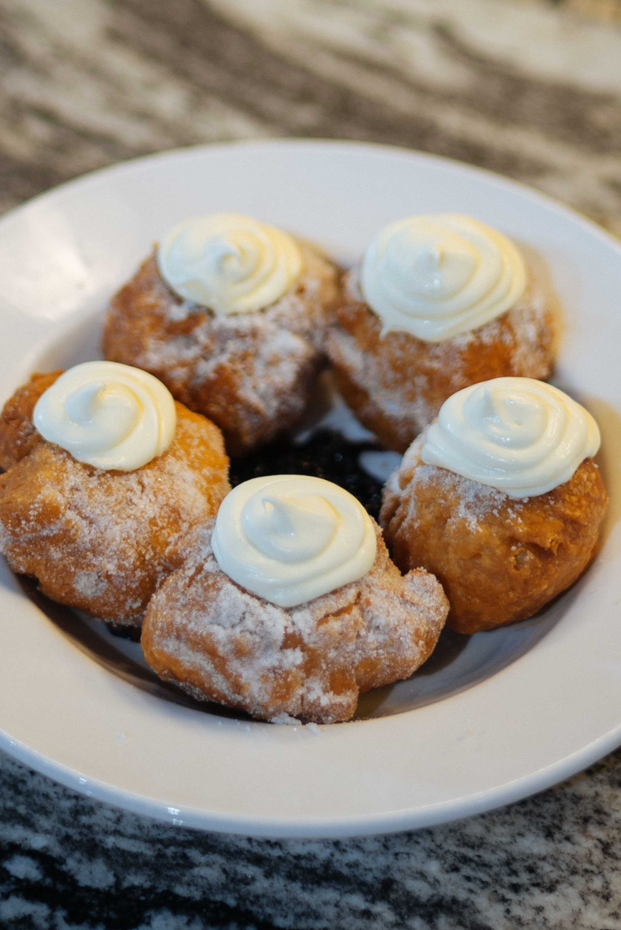 biscuit love in Nashville's bonuts topped with lemon mascarpone and served over blueberry compete taken by The Taste Edit