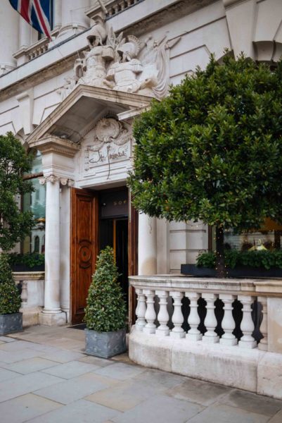 The Taste Edit culinary travel bloggers and photographers recommends when in London, stay at the Sofitel London St. James, one of the best luxury hotels in London with it's spectacular entrance and greenery framing the door #travel #london #hotel