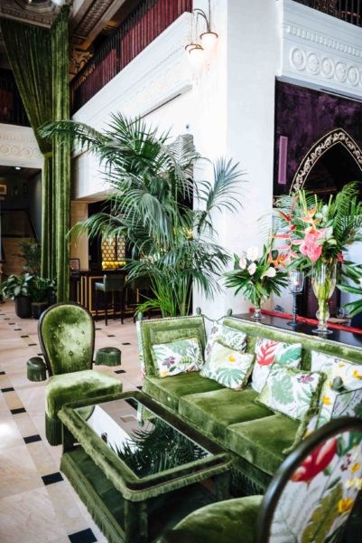 Green Decor in the lobby with green couches and flowers at The Nomad Hotel in downtown LA restaurant