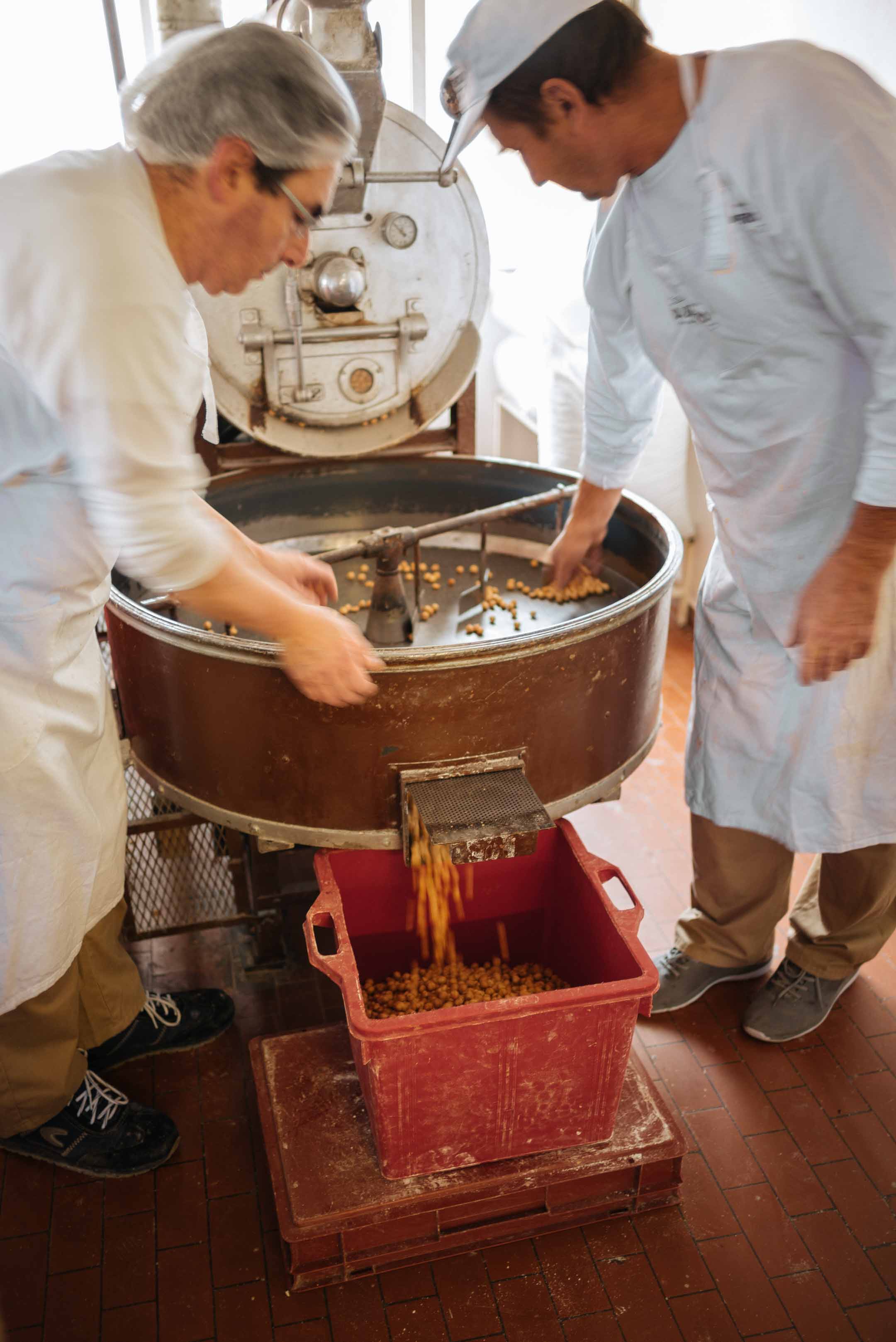Tour a behind the scenes look at D. Barbero torrone and chocolate factory in Asti, piedmont - roasting local hazelnuts
