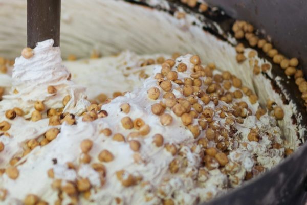 Tour a behind the scenes look at D. Barbero torrone and chocolate factory in Asti, piedmont - adding the roasting local hazelnuts to the candy