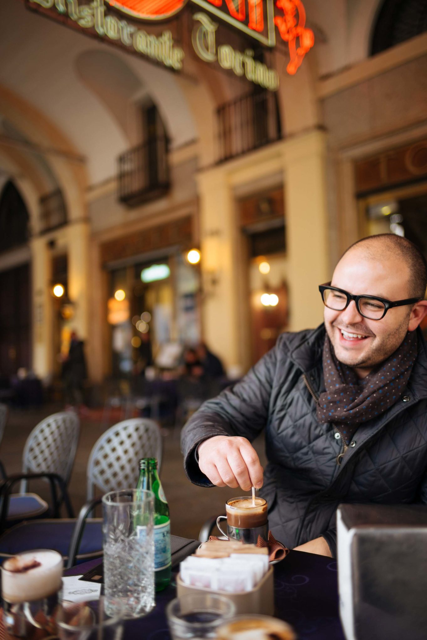 Have a cocktail or coffee at the historic Caffe Torino under the vintage martini sign in italy