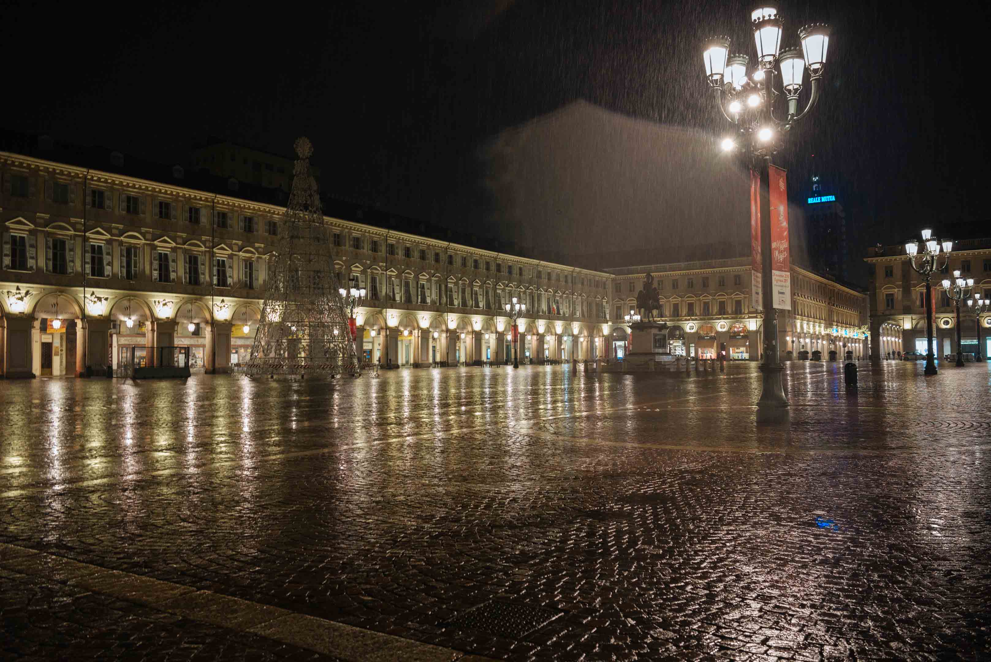 Caffe Torino and Piazza at night in Torino in the rain